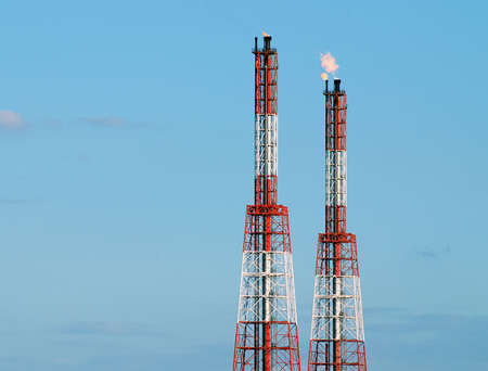 Refinery tower with fire blaze from the burning gasの写真素材