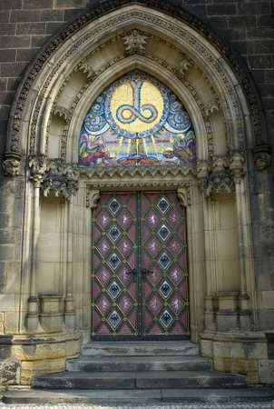 Massive stone gothic portal with mosaic in Pragueの写真素材