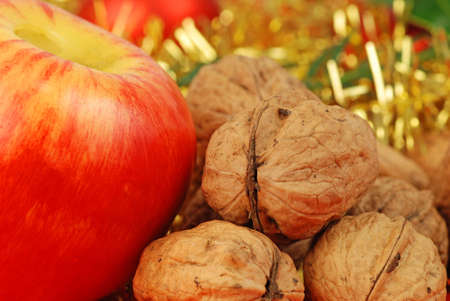 Christmas background - apple and nuts on gold ribbonの写真素材