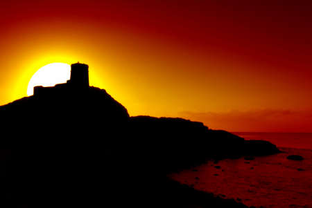 Romantic castle on the cliff silhouette and beautiful sunsetの写真素材