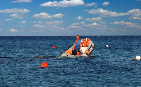 Coast guard is checking sea for drowning swimmersの写真素材