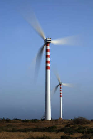 Two wind turbines generating energy - with motion blurの写真素材