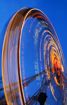 One of the crazy festival ferris wheels in Prague. Beautiful neon light show.の写真素材