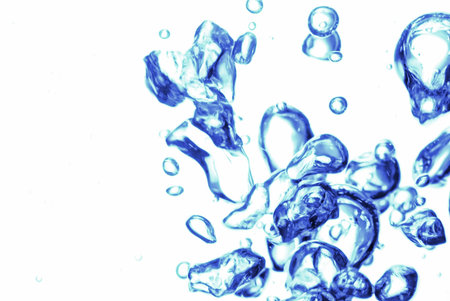 Blue air bubbles in fresh water on white background