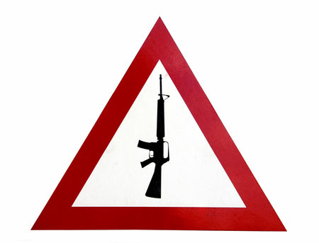 Red triangle warning sign that says arms and guns are forbiddenの写真素材