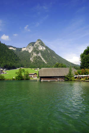 Famous lake Konikssee and a view at harbor and Alps peaks の写真素材