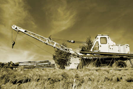 Old rusty crane in the wilderness in monochromatic sepiaの写真素材