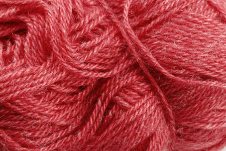 Detail of a red knitting skein- fabric background