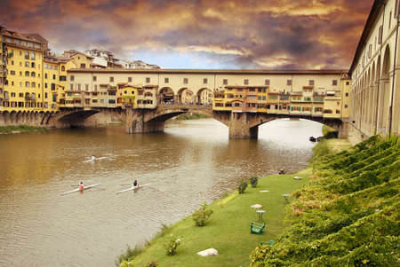 Beautiful sunset over of the oldest bridge over the river Arno in Florence Ponte Vecchioの写真素材