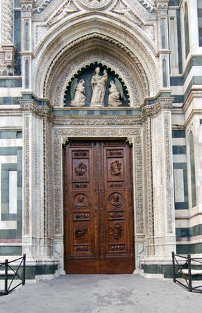 Beautiful renaissance wooden door of the cathedral Santa Maria del Fiore in Florence, Italyの写真素材