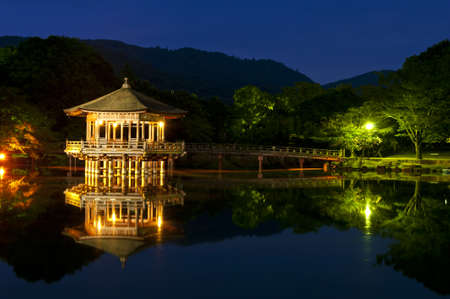 Nice japanese wooden gazebo is shortly after the sunset reflecting in the water. Nara, Japan.の写真素材