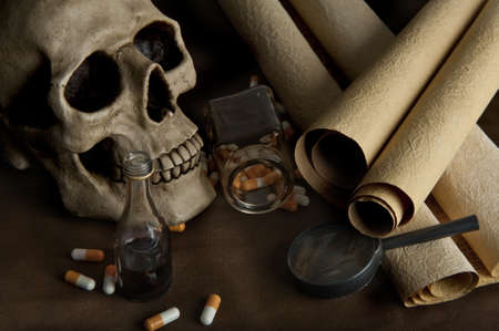 Scientific still life  with skull, old documents and various pillsの写真素材