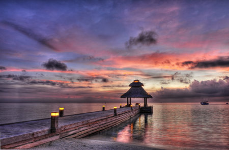 Awsome vivid sunset over the jetty in the Indian ocean, Maldives. HDR の写真素材