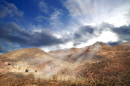 Not only sand dunes, but also arid mountains are a face of mighty desert Sahara. Here with dramatic sky after the stormの写真素材