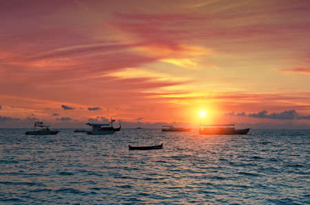 Vivid sunset over the harbor in the Maldivesの写真素材