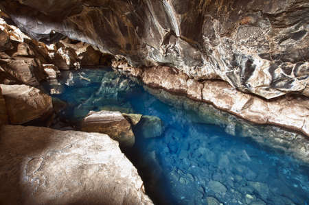 Volcanic cave Grjotagja with a incredibly blue and hot thermal water near lake Myvatn in the northeastern Icelandの写真素材