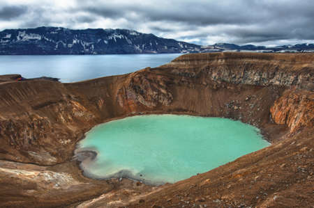 volcano Askja offers a view at two crater lakes. The smaller, turquoise one is called Viti and contains warm geothermal water and is good for swimming. The large lake is Oskjuvatn, the second deepest lake on the Iceland.の写真素材