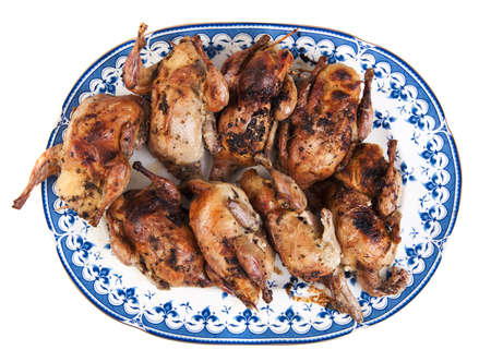 Big plate full of freshly roasted quails isolated on white の写真素材