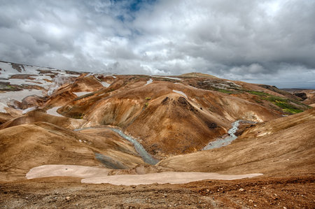 Iceland is a land of ice and fire. In the geothermal area Kerlingarfjoll one can see smoke and boiling fumaroles from the geothermal field as well as mountains covered by ice and snow.の写真素材