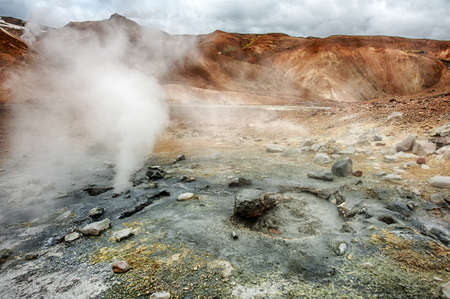 Iceland is a land of ice and fire. In the geothermal area Kerlingarfjoll one can see smoke and boiling fumaroles from the geothermal field as well as mountains covered by ice and snow.の写真素材
