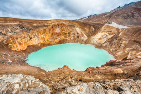 Giant volcano Askja offers a view at two crater lakes. The smaller, turquoise one is called Viti and contains warm geothermal water and is good for swimming. The large lake is Oskjuvatn, the second deepest lake on the Iceland.の写真素材