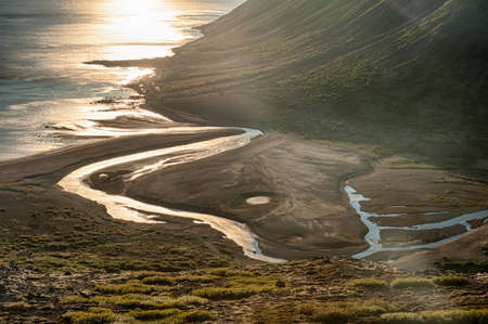 Sun is setting over the fjord on the Icelandの写真素材