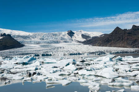 Beautiful photo of Fjallsarlon Glacial lake full of floating icebergs near the Fjallsjokull glacierの写真素材