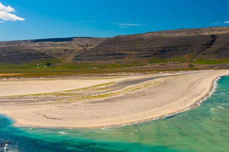 Extremly beautiful bay with mighty golden beaches and turquise sea in the West Fjords, Iceland. Panoramic photoの写真素材