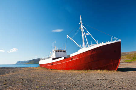 Old fishing boat that shipwrecked in one of the fjords of the Iceland in the Westfjords の写真素材