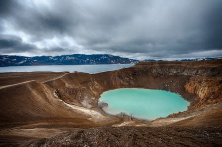 Giant volcano Askja offers a view at two crater lakes. The smaller, turquoise one is called Viti and contains warm geothermal water and is good for swimming. The large lake is Oskjuvatn, the second deepest lake on the Iceland.の写真素材