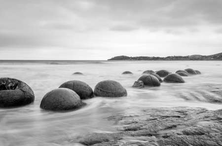 Moeraki Boulders on the Koekohe beach, Eastern coast of New Zealand. HDR image, black and whiteの写真素材