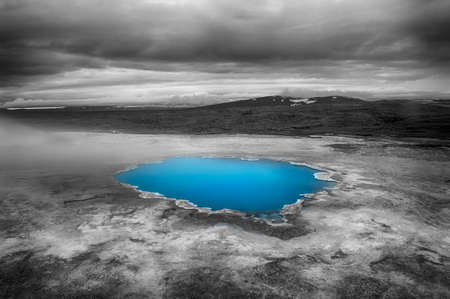 Incredibly blue pool Blahver at Hveravellir is actually a hot geothermal spring in the heart of Iceland. Photo taken around midnight with a storm coming の写真素材