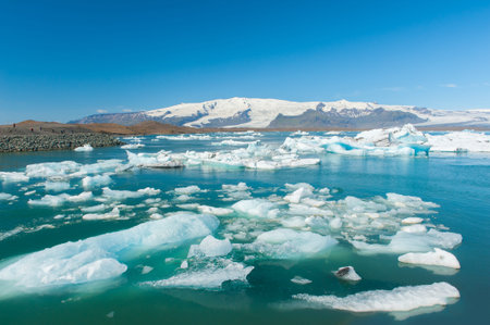Detailed photo of the Icelandic glacier icebergs in a ice lagoon with incredibly vivid colors and a...
