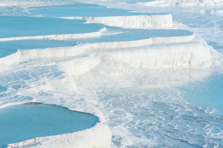Blue pools and white travertine terraces at Pamukkale, Turkeyの写真素材