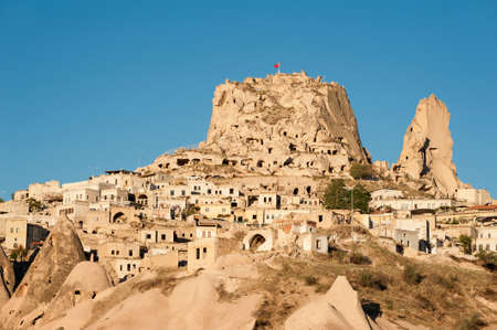 Ancient town and a castle of Uchisar dug from a mountains after sunrise, Cappadocia, Turkeyのeditorial素材
