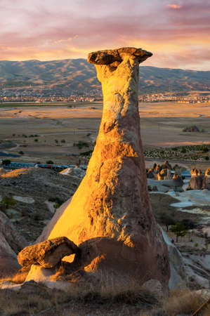 Rocks looking like mushrooms dramatically lit by a sunset in Cappadocia, Turkeyの写真素材