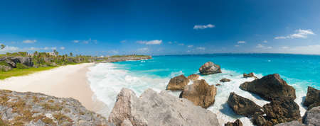 Harrismith Beach is one of the most beautiful beaches on the Caribbean island of Barbados. It is a tropical paradise with palms hanging over turquoise sea and a ruin of an old mansion on the cliffの写真素材