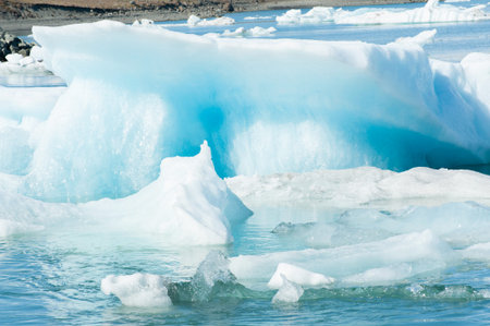 Detailed photo of the Icelandic glacier iceberg in a ice lagoon with incredibly vivid colors and a...