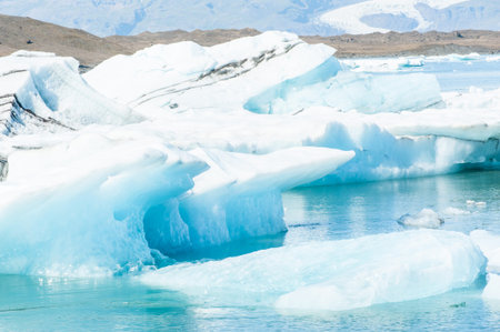Detailed photo of the Icelandic glacier iceberg in a ice lagoon with incredibly vivid colors and a...