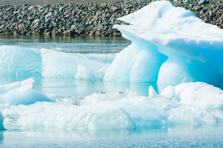 Detailed photo of the Icelandic glacier iceberg in a ice lagoon with incredibly vivid colors and a nice textureの写真素材