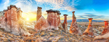 Rocks looking like mushrooms dramatically lit by a sunset in Cappadocia, Turkeyの写真素材