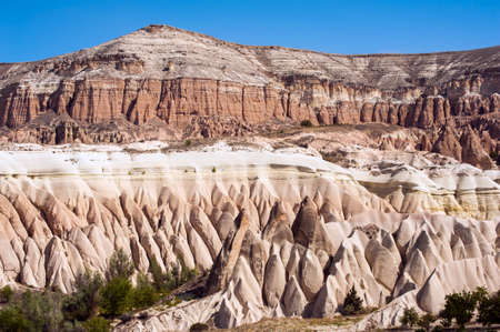 Detailed photo of vivid pink rock formations with caves from above in Cappadocia, Turkeyの写真素材