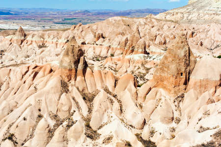 Detailed photo of vivid pink rock formations with caves from above in Cappadocia, Turkeyの写真素材