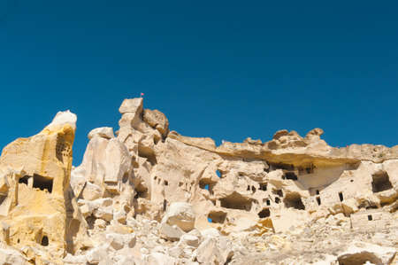Detail of the ancient castle of Cavusin dug from a mountains, Cappadocia, Turkeyの写真素材