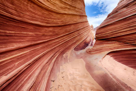 The Wave is an awesome vivid swirling petrified dune sandstone formation in Coyote Buttes North. It could be seen in Paria Canyon-Vermilion Cliffs Wilderness, Arizona. USAの写真素材