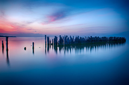 Old broken pier at sunset on the coast of the Baltic sea, Latviaの写真素材