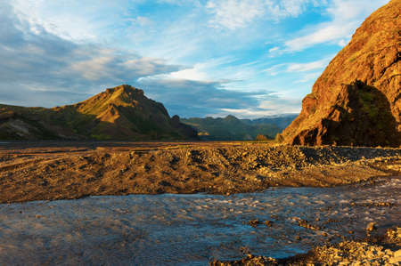 Midnight setting sun lits beautifully volcanic rocks at Thorsmork, Icelandの写真素材