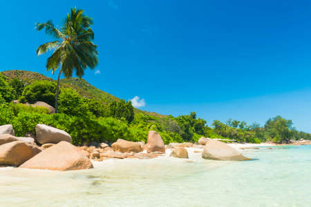 Beautiful beach Anse Takamaka seen from the granite boulders, La Digue island, Seychelles. Panoramaの写真素材
