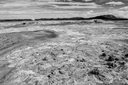 Mudpot in the geothermal area Hverir, Iceland. The area around the boiling mud is cracked.の写真素材