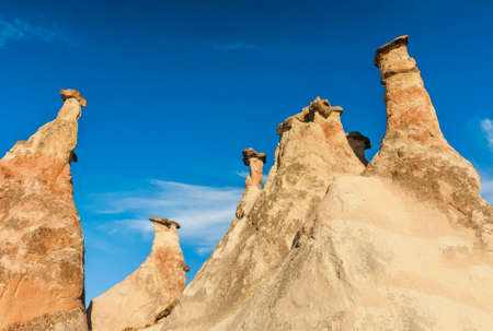 Rocks looking like mushrooms  lit by a setting sun in Cappadocia, Turkeyの写真素材